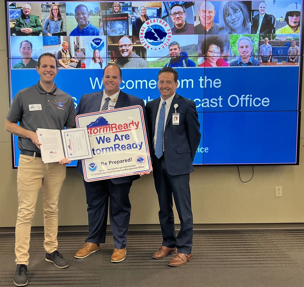 (From left to right) Jason Frazier of the National Weather Service presents Josh Cook, director of WVUH Emergency Management; and Michael A. Grace, Ed.D., M.B.A., F.A.C.H.E., WVUH president and CEO, with StormReady Certification on June 17. 