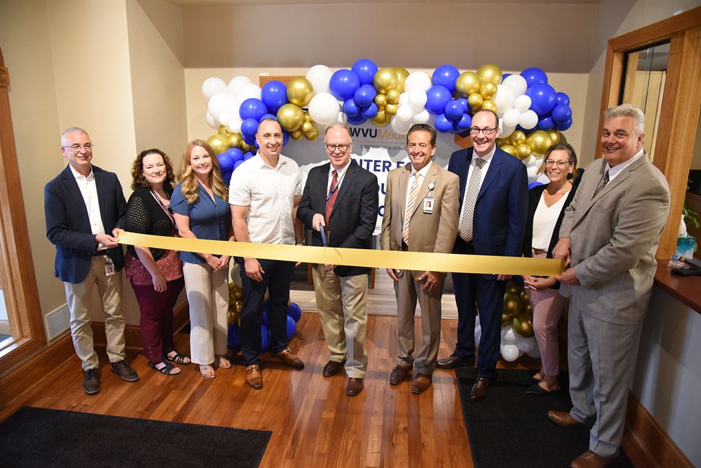 WVU Medicine officials gathered on Wednesday (June 25) to cut the ribbon on the expanded Center for Reproductive Medicine (CRM). Pictured from left to right are Dr. Michael Edmond, WVU Health System chief medical officer; Natica Glover, Department of Obstetrics, Gynecology, and Reproductive Sciences associate administrator; Jodi DeFelice; Department executive administrator; Dr. Ryan Heitmann, CRM medical director; Dr. Brian Casey Department chair; Dr. Michael Grace, WVU Hospitals president and CEO; Albert L. Wright, Jr., WVU Health System president and CEO; Carla Swanson, CRM clinic manager; and Darin Rogers, WVU Health System chief ambulatory operations officer.