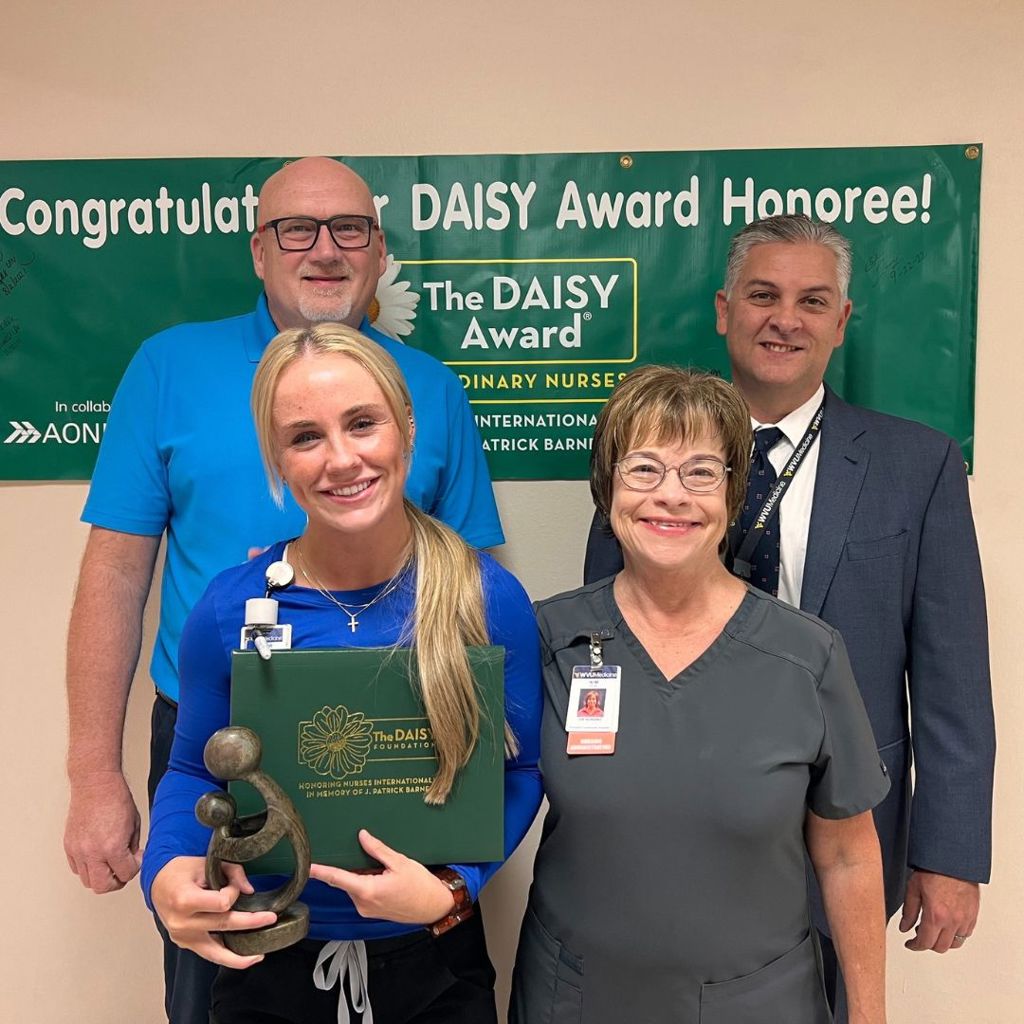 Taylor Allison, RN, received her DAISY Award from Kim Poe, director of ICU/CCU; Tim Anderson, vice president, nursing and CNO; and Al Boland, vice president, operations.