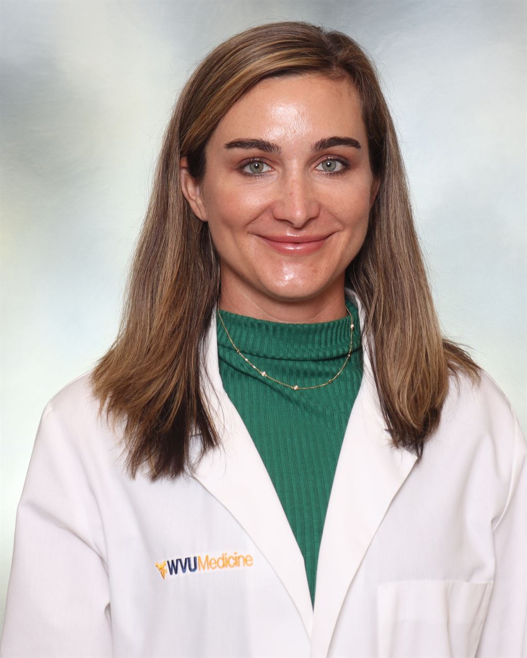 Dr. Zubowicz poses for a photo in a lab coat