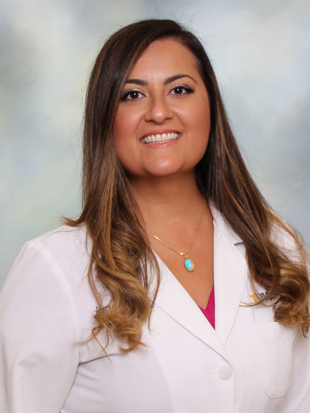 A posed photo of Dr. Sichani in a lab coat