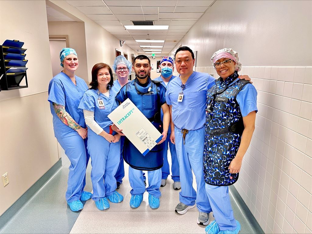 A group of providers in scrubs pose for a photo celebrating the Intracept procedure.