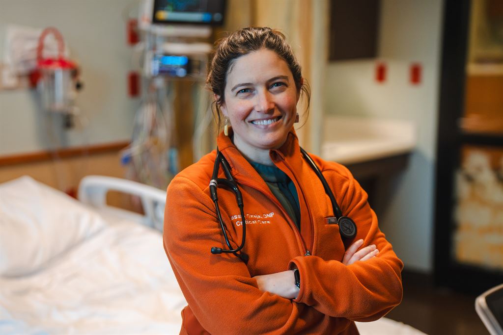 Cassie Czaja stands in an orange sweater with a stethoscope around her neck.