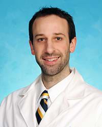 man-dark-hair-white-coat