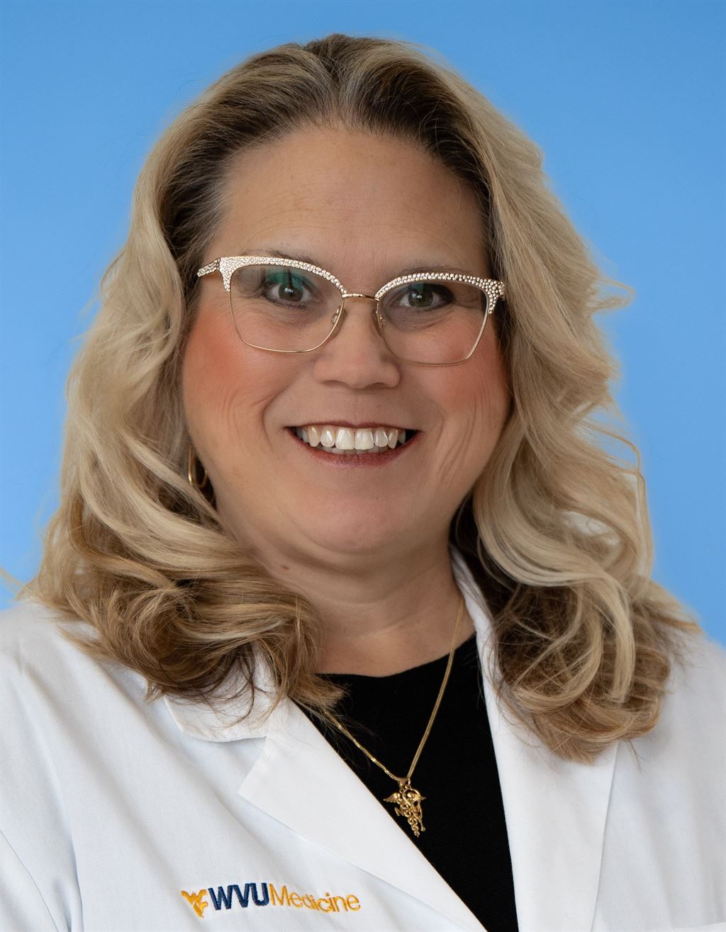 A photo of Kate Smith in a lab coat.