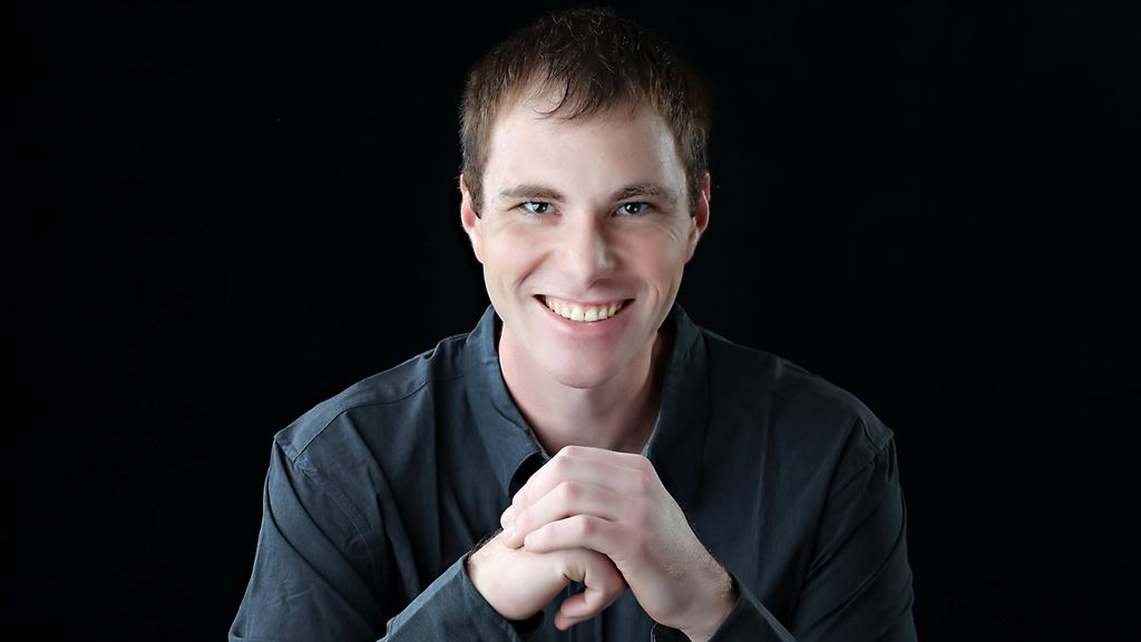 man-black-shirt-hands-folded