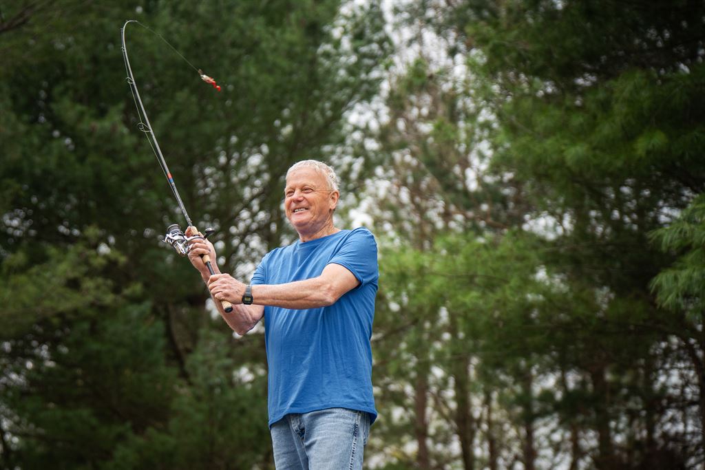 WVU Medicine Orthopaedics patient Rick casts a fishing line in Jefferson County after a successful shoulder surgery.