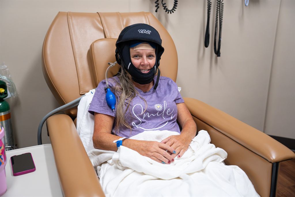 WVU Cancer Institute patient Paula poses for a photo with the Cooling Cap.
