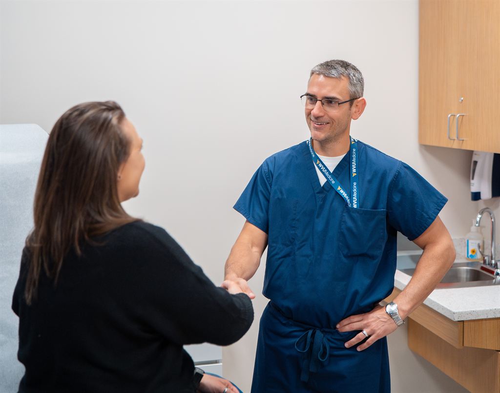 Dr. Seth Eberhardt speaks to a foot and ankle patient at WVU Medicine Orthoapedics in Spring Mills, West Virginia.