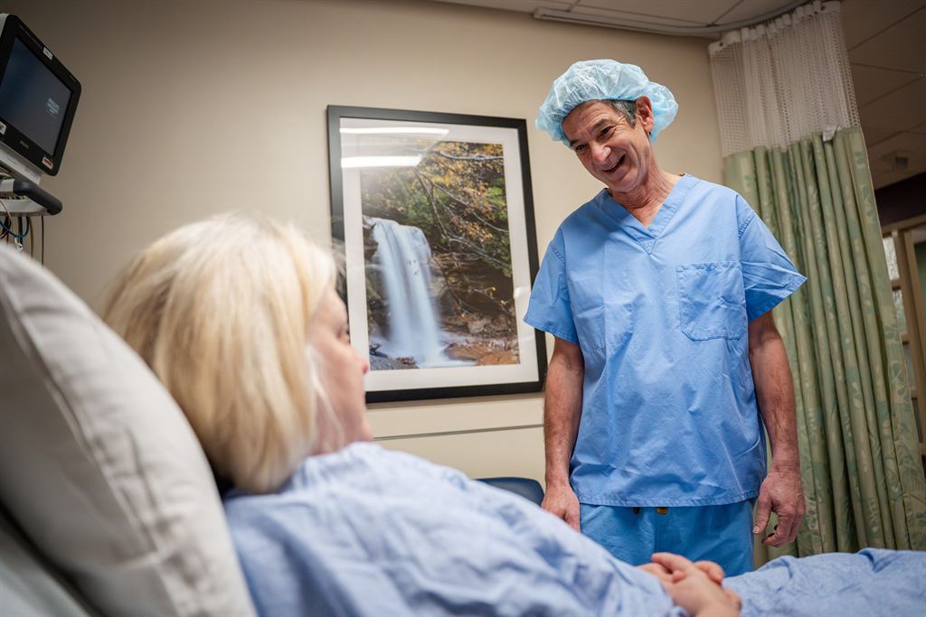 Dr. Jack Gelman speaks with a plastic surgery patient.