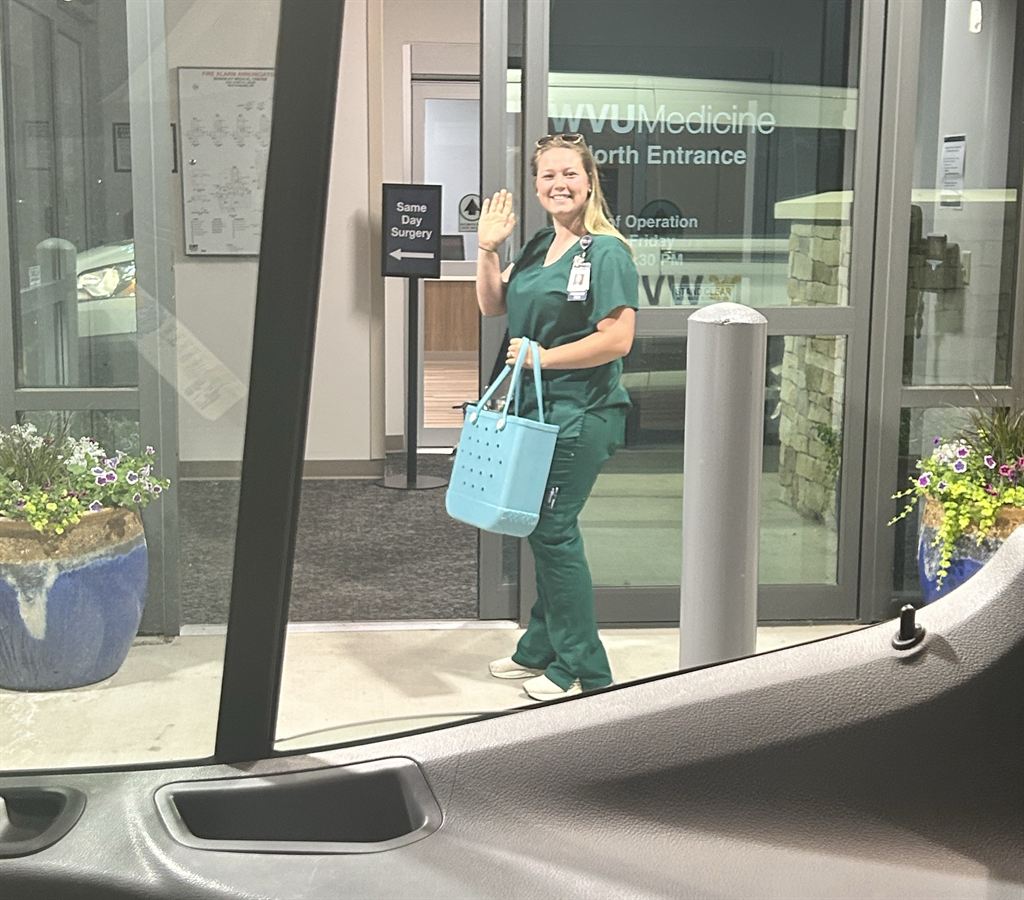 A WVU Medicine employee exits a shuttle