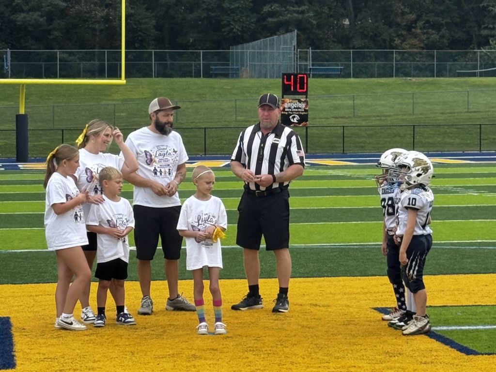 Youth football players and local Hedgesville families on the football field during Ava May Day