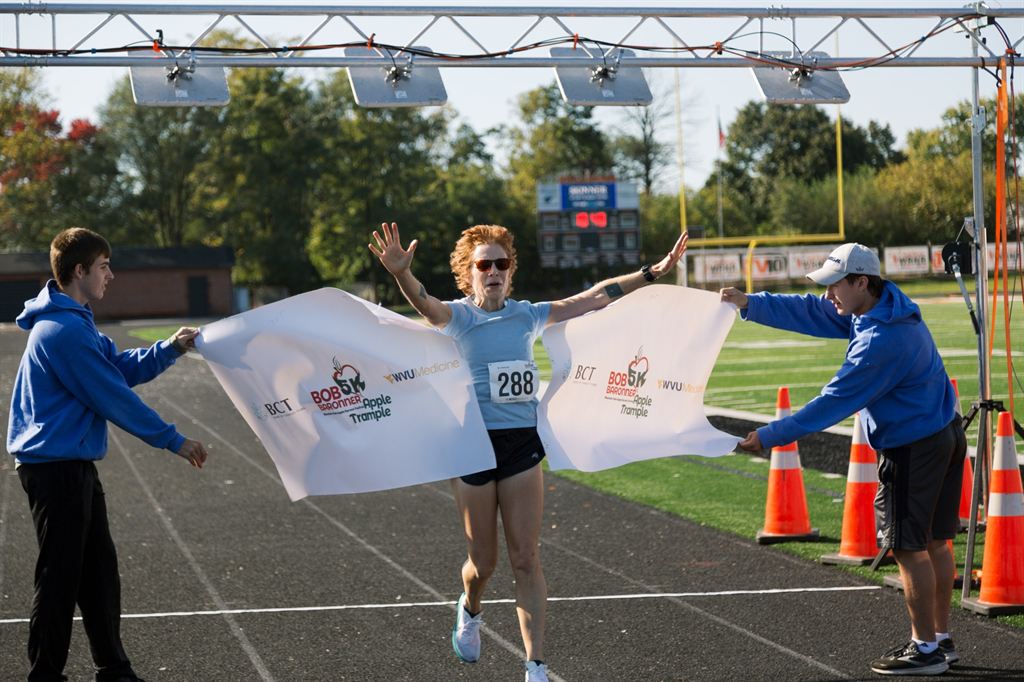 A runner finishes the Apple Trample 5K