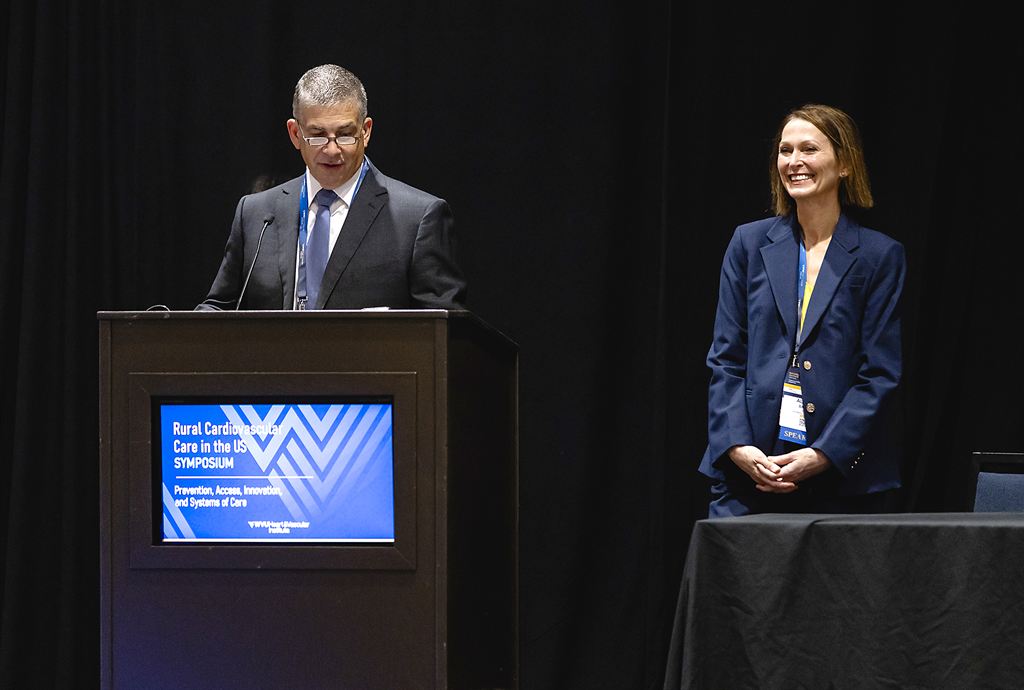 man-at-podium-woman-standing-at-table