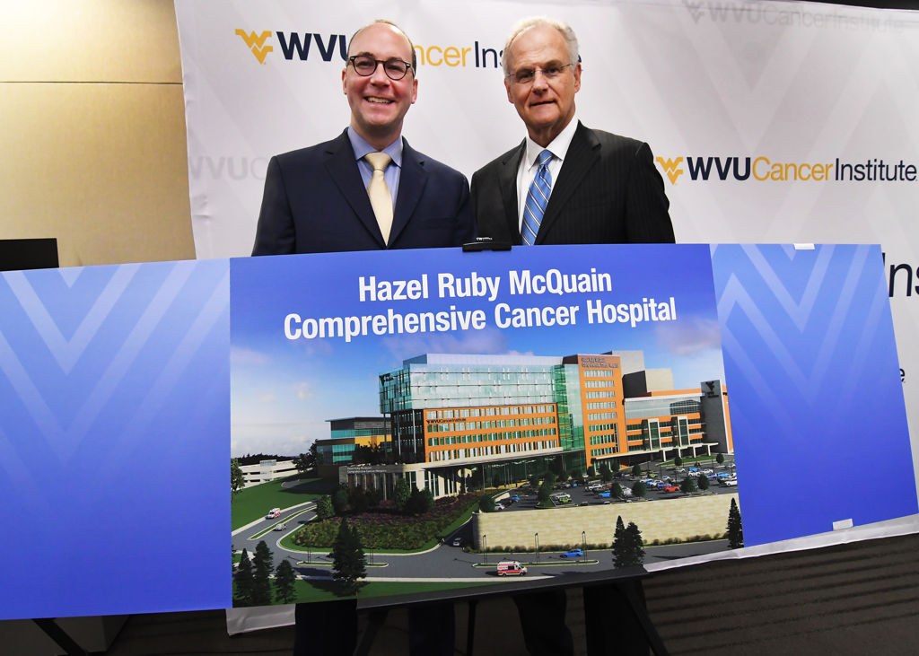 (Left to right) Albert L. Wright, Jr., president and CEO of the West Virginia University Health System, and Steve Farmer, chair of the Hazel Ruby McQuain Charitable Trust, unveil the artist's rendering of the new Hazel Ruby McQuain Comprehensive Cancer Hospital of the WVU Cancer Institute on Tuesday, April 2.