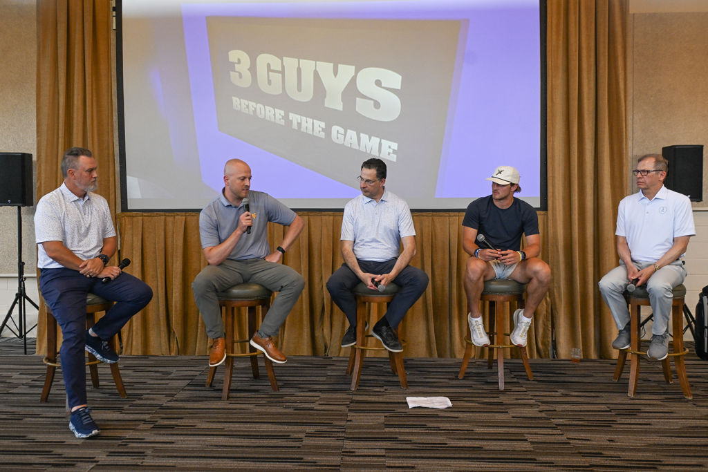 Brad Howe, Blaine Stewart, Tony Caridi, Garrett Greene, and Hoppy Kercheval chat during the live show at the WVU Cancer Institute Golf Classic after-event.