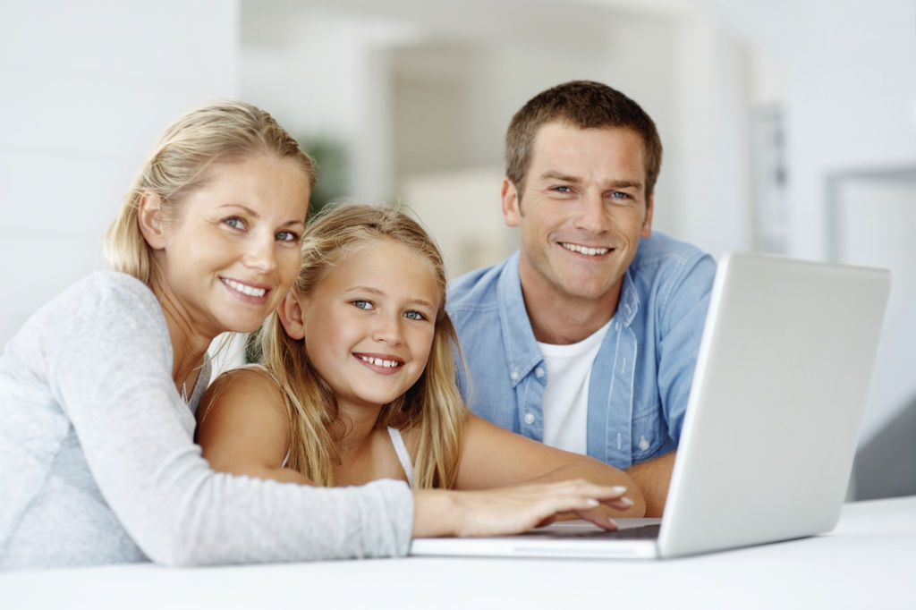 Father, mother, and daughter on computer