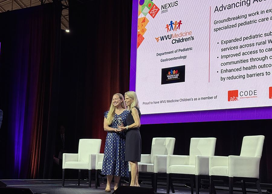 Audra Rouster, M.D., chief of pediatric gastroenterology at WVU Medicine Children&rsquo;s (left), receives the Advancing Access to Virtual Care Award at the ATA NEXUS conference.